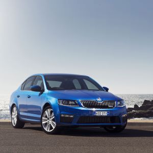 Carro Skoda Azul à Beira do Oceano